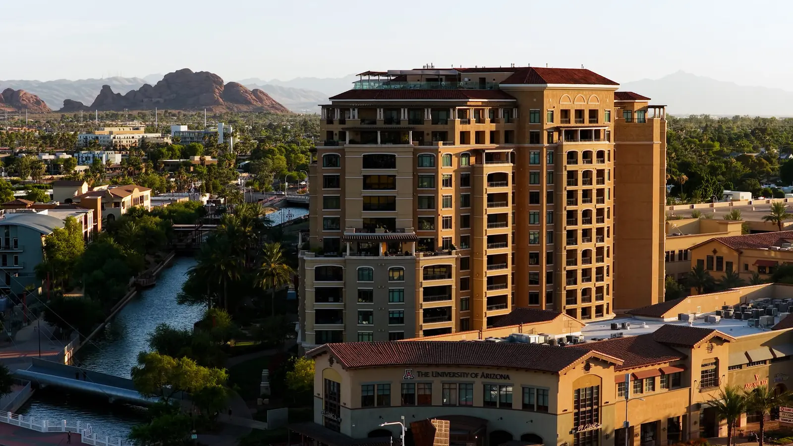 Mid-rise building beside the Arizona canal at golden hour