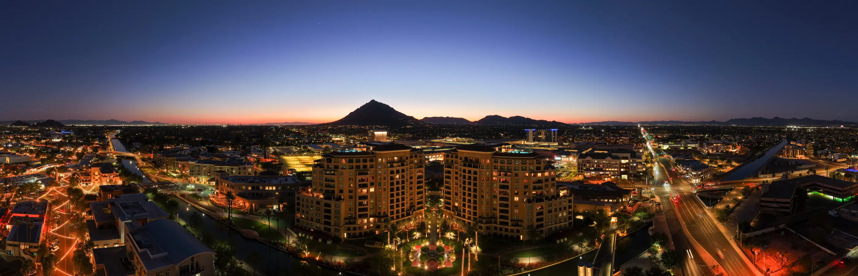 Wide panoramic aerial of Old Town Scottsdale at blue hour